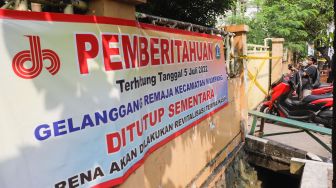 Garis polisi terpasang di pintu pagar Gelanggang Olahraga (GOR) Mampang setelah peristiwa robohnya tembok proyek revitalisasi di Pela Mampang, Jakarta Selatan, Selasa (2/8/2022). [Suara.com/Alfian Winanto]