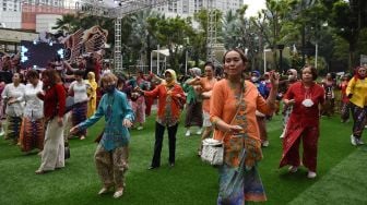 Sejumlah perempuan dari berbagai komunitas wanita berkebaya menari dan berdansa dalam acara Kebaya Berdansa di Tribeca Park, Jakarta, Sabtu (27/8/2022).  ANTARA FOTO/Indrianto Eko Suwarso