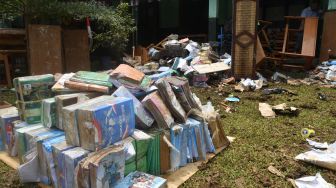 Sejumlah guru dan pegawai sekolah membersihkan meja dan kursi yang basah pasca banjir di SMK Nusantara, Kota Bogor, Jawa Barat, Rabu (31/8/2022). [ANTARA FOTO/Arif Firmansyah/aww]