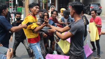 Polisi berusaha menghalau sejumlah mahasisiswa yang akan membakar ban bekas saat berunjukrasa di depan gedung DPRD Kabupaten Jombang, Jawa Timur, Kamis (1/9/2022).  ANTARA FOTO/Syaiful Arif