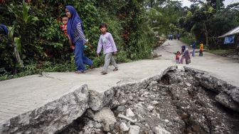 Kondisi jalan yang terbelah akibat pergerakan tanah di Bojong Koneng, Babakan Madang, Kabupaten Bogor, Jawa Barat, Jumat (16/9/2022).  ANTARA FOTO/Yulius Satria Wijaya