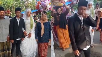 Berjalan Menuju Pelaminan, Warganet Dibuat Bingung dengan Penampilan Pengantin Pria