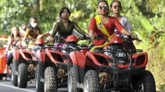 Perempuan Berkebaya di Bali Lakukan Aktivitas Mulai Memasak Hingga Kemudikan ATV