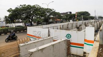 Pekerja menyelesaikan proses pembangunan underpass di Jalan Dewi Sartika, Depok, Jawa Barat, Rabu (9/11/2022). [Suara.com/Alfian Winanto]