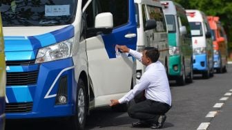 Petugas memasang stiker kendaraan khusus pada salah satu ambulans VVIP untuk KTT G20 dalam apel dan pengarahan tim medis di Nusa Dua, Kabupaten Badung, Bali, Sabtu (12/11/2022). ANTARA FOTO/Media Center G20 Indonesia/Aditya Pradana Putra

