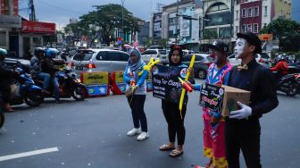 Anggota badut Depok menggalang dana untuk korban gempa bumi Cianjur di Margonda, Depok, Jawa Barat, Senin (28/11/2022). [Suara.com/Alfian Winanto]