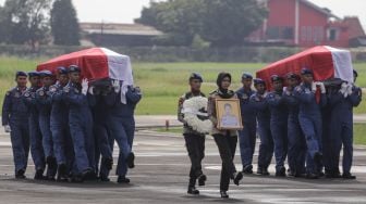 Sejumlah prajurit Polri membawa peti jenazah CoPilot helikopter milik Polri NBO-105 Briptu M Lasminto dan peti jenazah mekanik helikopter Bripda Khairul Anam saat upacara penyerahan jenazah di Lapangan Terbang Polisi Udara, Pondok Cabe, Tangerang Selatan, Banten, Rabu (30/11/2022). [ANTARA FOTO/Fauzan/YU]