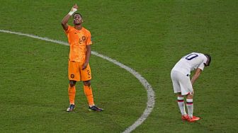 Bek Belanda Jurrien Timber selebrasi di samping penyerang Amerika Christian Pulisic setelah timnya menang saat pertandingan sepak bola babak 16 besar Piala Dunia 2022 antara Belanda dan AS di Khalifa International Stadium, Doha, Qatar, Sabtu (3/12/2022). [Raul ARBOLEDA/AFP]