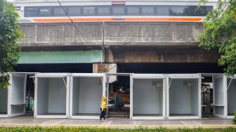 Warga melintas di dekat kios untuk pedagang kaki lima (PKL) di Jalan Penataran, kawasan Tugu Proklamasi, Jakarta Pusat, Selasa (17/1/2023).  [Suara.com/Alfian Winanto]