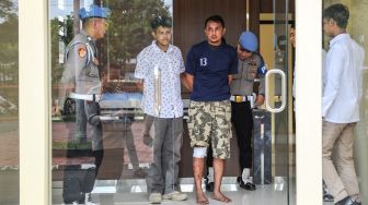 Polisi menggiring tersangka kasus pembacokan mantan Ketua Komisi Yudisial Jaja Ahmad Jayus, Adt (ketiga kiri), di Polresta Bandung, Soreang, Kabupaten Bandung, Jawa Barat, Rabu (29/3/2023). [ANTARA FOTO/Raisan Al Farisi].