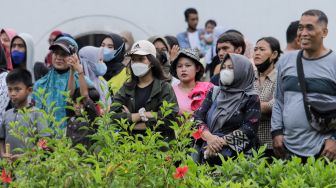 Pengunjung memakai masker saat berwisata di Kawasan Kota Tua, Jakarta Barat, Sabtu (6/5/2023). [Suara.com/Alfian Winanto]