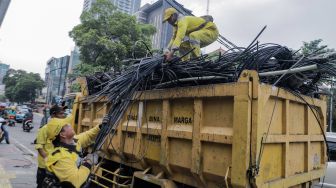 Petugas Dinas Bina Marga DKI Jakarta melakukan penataan kabel utilitas di sekitar Jalan Haji Agus Salim, Jakarta Pusat, Rabu (24/5/2023). [Suara.com/Alfian Winanto]