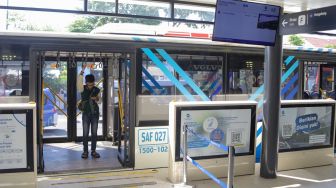 Calon penumpang menunggu kedatangan bus Transjakarta di Halte Transjakarta Kampung Melayu, Jakarta, Rabu (19/7/2023). [Suara.com/Alfian Winanto]