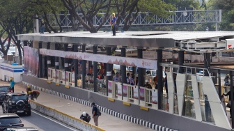 Pekerja menyelesaikan proyek revitalisasi Halte Bundaran Senayan di Jalan Jenderal Sudirman, Jakarta, Rabu (30/8/2023). [Suara.com/Alfian Winanto]