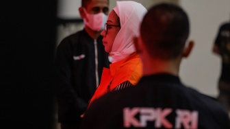 Tersangka mantan Direktur Utama (Dirut) Pertamina Karen Agustiawan (tengah) mengenakan baju tahanan saat dihadirkan dalam konferensi pers pengumuman penahanan tersangka di Gedung Merah Putih KPK, Jakarta, Selasa (19/9/2023). [Suara.com/Alfian Winanto]