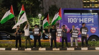 Sejumlah aktivis dari Greenpeace saat menggelar aksi solidaritas untuk Palestina di kawasan Bundaran HI, Jakarta, Jumat (3/11/2023). [Suara.com/Alfian Winanto]