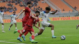 Pesepak bola Timnas Inggris U-17 Golding Michael berusah melewati Pemain Timnas Iran U-17 pada pertandingan Grup C Piala Dunia U-17 2023 di Jakarta International Stadium (JIS), Jakarta, Selasa (14/11/2023). [Suara.com/Alfian Winanto]