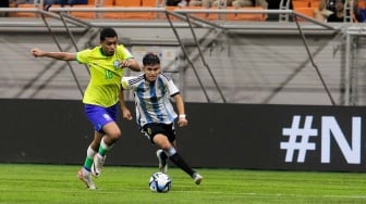 Pesepak bola Timnas Argentina U-17 Dylan Gorosito menggiring bola melewati pemain Timnas Brasil U-17 Joao Henrique pada pertandingan babak Perempat Final Piala Dunia U-17 2023 di Jakarta International Stadium (JIS), Jakarta, Jumat (24/11/2023). [Suara.com/Alfian Winanto]