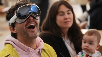 Seorang pelanggan mencoba Vision Pro-nya saat peluncurannya di Apple The Grove di Los Angeles, California, Amerika Serikat, Jumat (2/2/2024). [David SWANSON / AFP]
