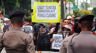 Massa dari Masyarakat Sipil Peduli Pemilu dan Demokrasi saat menggelar demo di depan Gedung Komisi Pemilihan Umum (KPU) RI, Jakarta, Jumat (16/2/2024). [Suara.com/Alfian Winanto]