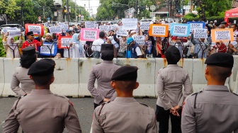 Massa dari Masyarakat Sipil Peduli Pemilu dan Demokrasi saat menggelar demo di depan Gedung Komisi Pemilihan Umum (KPU) RI, Jakarta, Jumat (16/2/2024). [Suara.com/Alfian Winanto]