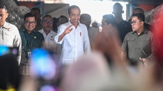 Presiden Joko Widodo menyapa warga saat meninjau persedian beras serta penyerahan bantuan pangan beras cadangan pangan pemerintah kepada Keluarga Penerima Manfaat (KPM) di gudang Bulog, Cibitung, Bekasi, Jawa Barat, Jumat (16/2/2024). [ANTARA FOTO/Muhammad Adimaja/aww]