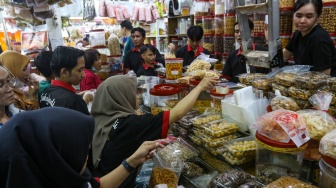 Warga membeli kue kering di salah satu pusat penjualan kue di pasar Jatinegara, Jakarta, Kamis (28/3/2024). [Suara.com/Alfian Winanto]