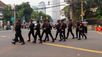 Sejumlah personel Brimob melakukan penjagaan di Gedung Komisi Pemilihan Umum (KPU) RI, Jakarta, Rabu (24/4/2024). [Suara.com/Alfian Winanto]