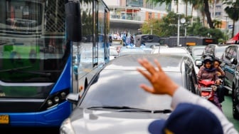 Sejumlah kendaraan terjebak kemacetan di kawasan Bundaran HI, Jakarta, Rabu (1/5/2024). [Suara.com/Alfian Winanto]