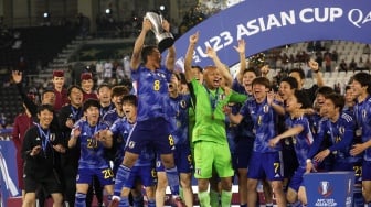 Para pemain Jepang selebrasi dan mengangkat trofi setelah memenangkan pertandingan final Piala Asia U23 2024 antara Jepang melawan Uzbekistan di Stadion Jassim Bin Hamad, Doha, Qatar, Jumat (3/5/2024). [KARIM JAAFAR / AFP]