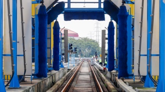 Pekerja melakukan pengecekan Automatic Train Washing Point (ATWP) pada jalur Light Rail Transit (LRT) Jakarta di Depo LRT Jakarta Pegangsaan Dua, Jakarta, Rabu (8/5/2024). [Suara.com/Alfian Winanto]