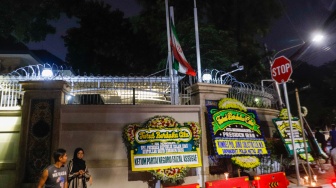 Bendera setengah tiang berkibar di depan Kantor Kedutaan Besar Iran, Jakarta, Senin (20/5/2024). [Suara.com/Alfian Winanto]