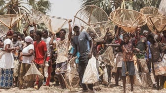 Masyarakat berkumpul sambil memegang jaring ikan menunggu dimulainya ritual penangkapan ikan Sanke Mon di San, Wilayah Sego, Mali, Kamis (6/6/2024). [OUSMANE MAKAVELI / AFP] 