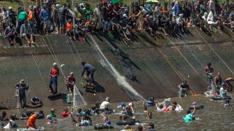 Sejumlah warga menjaring ikan saat Kurasan Kolam Tando Harian Sub Unit Pembangkit Listrik Tenaga Air (PLTA) Timo di Desa Tlompakan, Kecamatan Tuntang, Kabupaten Semarang, Jawa Tengah, Senin (5/8/2024). [ANTARA FOTO/Aji Styawan/foc]