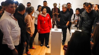 Presiden ke-5 RI Megawati Soekarnoputri (tengah) didampingi pematung Dolorosa Sinaga saat melihat pameran seni patung di Galeri Nasional, Jakarta, Kamis (8/8/20204). [Suara.com/Alfian Winanto] 