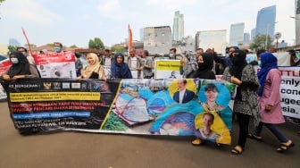 Sejumlah pencari suaka berunjuk rasa di depan kantor United Nations High Commissioner for Refugees (UNHCR) di Kuningan, Jakarta, Senin (12/8/2024). [Suara.com/Alfian Winanto]