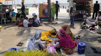 Pengunjung bermain air di Pantai Lagoon, Ancol Taman Impian, Jakarta, Senin (16/9/2024). [Suara.com/Alfian Winanto]