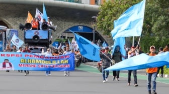 Massa dari Konfederasi Serikat Pekerja Indonesia (KSPI) melakukan pawai kemenangan satu putaran untuk paslon gubernur-wakil gubernur nomor urut 3 Pramono Anung-Rano Karno di Bundaran HI, Jakarta, Jumat (29/11/2024). [Suara.com/Alfian Winanto]