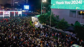 Suasana padatnya warga saat Car Free Night menyambut malam pergantian tahun di Bundaran HI, Jakarta, Selasa (31/12/2024). [Suara.com/Alfian Winanto]