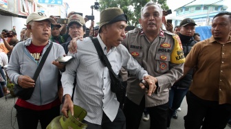 Anggota polisi mencoba menenangkan warga yang mengamuk saat antre membeli gas elpiji 3 kilogram di Karawaci, Tangerang, Banten, Selasa (4/2/2025). [ANTARA FOTO/Muhammad Iqbal/YU]