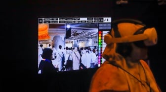 Pengunjung menggunakan perangkat virtual reality (VR) saat simulasi manasik haji di arena Manasik Xperience, Kuningan City, Jakarta, Senin (10/3/2025). [Suara.com/Alfian Winanto]