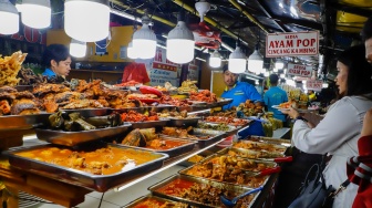 Pengunjung memilih menu berbuka puasa di Sentra kuliner Nasi Kapau di Jalan Kramat Raya, Senen, Jakarta, Selasa (18/3/2025). [Suara.com/Alfian Winanto]
