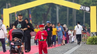 Warga mengunjungi acara Lebaran Betawi 2025 di kawasan Monumen Nasional (Monas), Jakarta, Sabtu (26/4/2025). [Suara.com/Alfian Winanto]