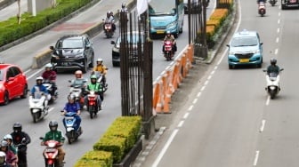 Pengendara melintas di dekat tiang bekas proyek monorel Jakarta di kawasan Jalan HR Rasuna Said, Jakarta, Senin (2/6/2025). [Suara.com/Alfian Winanto]