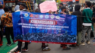 Massa dari Ikatan Pelajar dan Mahasiswa Moni (IPMMO) saat menggelar aksi unjuk rasa di depan Gedung Kementerian HAM, Jakarta, Selasa (3/6/2025). [Suara.com/Alfian Winanto]