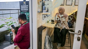 Pelanggan meminun kopi di Kopi Difabis, Terowongan Kendal, Jakarta, (9/6/2025). [Suara.com/Alfian Winanto]