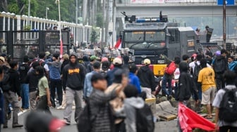 Personel polisi menghalau pengunjuk rasa di Jalan Letjend S Parman, depan Gedung DPR, Jakarta, Senin (25/8/2025). [ANTARA FOTO/Bayu Pratama S/rwa]