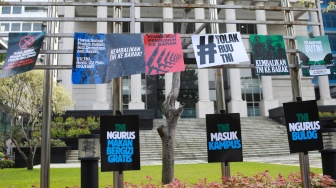 Peserta aksi yang tergabung dalam Koalisi Masyarakat Sipil Untuk Reformasi Sektor Keamanan mengangkat poster saat mengikuti aksi di depan Gedung Mahkamah Konstitusi (MK), Jakarta, Rabu (17/9/2025). [Suara.com/Alfian Winanto]