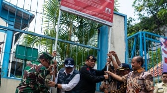 Tim gabungan Gakkum Kementerian Lingkungan Hidup bersama Polri dan TNI mencabut papan peringatan radiasi di salah satu pabrik yang telah didekontaminasi dari radiasi Cesium-137 (Cs-137) di Kawasan Industri Cikande, Kabupaten Serang, Banten, Jumat (8/10/2025). [ANTARA FOTO/Muhammad Bagus Khoirunas/foc]