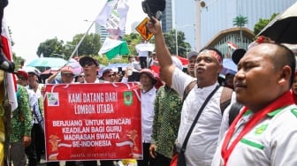 Guru honorer madrasah swasta dari berbagai wilayah di Indonesia berunjuk rasa di kawasan Monas, Jakarta, Kamis (30/10/2025). [Suara.com/Alfian Winanto]
